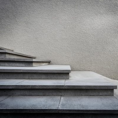 A concrete staircase leading up to a blank wall